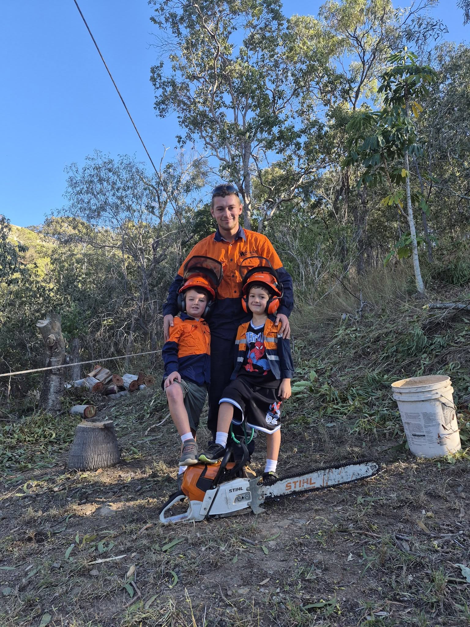 Archers Tree Services team member with two children in safety gear