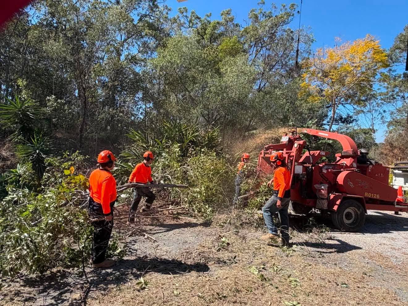 Archers crew operating a wood chipper